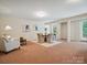 Sitting area with table and chairs plus a sofa and lamp at 5805 Copperleaf Commons Ct, Charlotte, NC 28277