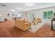 Large living room with sofas, coffee table, rug, and natural light at 5805 Copperleaf Commons Ct, Charlotte, NC 28277