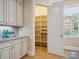 Walk-in pantry with custom shelving and storage cabinets at 5805 Copperleaf Commons Ct, Charlotte, NC 28277