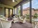 Comfortable screened porch with ceiling fan, furniture, grill, and outdoor view provides a relaxing space at 5805 Copperleaf Commons Ct, Charlotte, NC 28277
