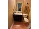 Compact bathroom showcasing a dark vanity with granite top and a standard white toilet at 5816 Rocky Mount Ct, Charlotte, NC 28214