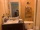 Compact bathroom with a granite vanity top, toilet, mirror and decorative wall accents at 5816 Rocky Mount Ct, Charlotte, NC 28214