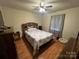 Cozy bedroom featuring a ceiling fan, wood flooring and an inviting queen-sized bed at 5816 Rocky Mount Ct, Charlotte, NC 28214