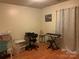 Bedroom with wood floors and tan walls, showing musical instruments and storage at 5816 Rocky Mount Ct, Charlotte, NC 28214