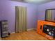 Bedroom with wood floors and purple walls, showing TV box and storage at 5816 Rocky Mount Ct, Charlotte, NC 28214