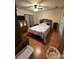 Relaxing bedroom featuring a dark ceiling fan, wood flooring and a large wooden dresser at 5816 Rocky Mount Ct, Charlotte, NC 28214