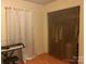 Bedroom with wood floors and tan walls, showing closet with see through mesh door at 5816 Rocky Mount Ct, Charlotte, NC 28214