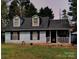 Charming home featuring dormer windows, light siding, and a welcoming front porch at 5816 Rocky Mount Ct, Charlotte, NC 28214