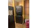 Stackable washer and dryer in the yellow kitchen with black refrigerator at 5816 Rocky Mount Ct, Charlotte, NC 28214