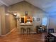 Open-concept living area with breakfast bar, wood floors, and adjacent dining space at 5816 Rocky Mount Ct, Charlotte, NC 28214