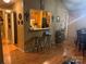 Inviting living space featuring wood floors, a pass-through to the kitchen, and barstool seating at 5816 Rocky Mount Ct, Charlotte, NC 28214