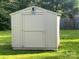 New backyard storage shed on green lawn with mature shade trees at 5816 Rocky Mount Ct, Charlotte, NC 28214