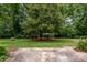 Mature trees and manicured lawn add to the beauty of this backyard at 5926 Sharon Rd, Charlotte, NC 28210