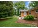 Brick home featuring a well maintained lawn and mature trees at 5926 Sharon Rd, Charlotte, NC 28210