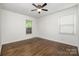 Bedroom featuring wood floors and natural light from two windows at 5926 Sharon Rd, Charlotte, NC 28210