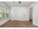 Bedroom with wood floors, a large window, and a closet with mirrored doors at 5926 Sharon Rd, Charlotte, NC 28210