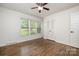 Bedroom featuring wood floors, large windows, and ample closet space at 5926 Sharon Rd, Charlotte, NC 28210