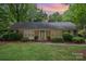 Charming brick home with a well-manicured lawn and mature trees at 5926 Sharon Rd, Charlotte, NC 28210