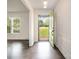 Bright foyer with dark wood floors and a green front door at 5926 Sharon Rd, Charlotte, NC 28210