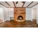 Cozy living room features a brick fireplace and custom built-in shelving at 5926 Sharon Rd, Charlotte, NC 28210