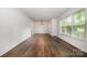 Spacious living room featuring wood floors and abundant natural light at 5926 Sharon Rd, Charlotte, NC 28210