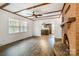 Spacious living room features a brick fireplace, wood floors, and natural light at 5926 Sharon Rd, Charlotte, NC 28210