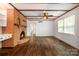 Living room showcasing brick fireplace, wood floors, and natural light at 5926 Sharon Rd, Charlotte, NC 28210