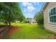 Expansive backyard with a lush lawn, mature trees, and manicured landscaping, offering an inviting outdoor space at 6007 Edinburgh Ln # 214, Indian Land, SC 29707