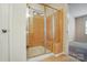 Bathroom showcasing a glass shower with a tiled seat and a door leading to the bedroom at 6007 Edinburgh Ln # 214, Indian Land, SC 29707
