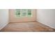 Bright bedroom featuring neutral carpet and three windows providing ample natural light at 6007 Edinburgh Ln # 214, Indian Land, SC 29707