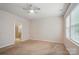Large bedroom with neutral carpet, ceiling fan and many windows bringing in natural light at 6007 Edinburgh Ln # 214, Indian Land, SC 29707