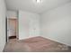 Bedroom featuring neutral carpet, a double door closet and a door leading to other parts of the house at 6007 Edinburgh Ln # 214, Indian Land, SC 29707