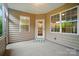 Cozy covered patio featuring two windows and an exit door, offering a comfortable space for outdoor relaxation at 6007 Edinburgh Ln # 214, Indian Land, SC 29707