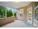 Inviting covered porch with screened windows and a door leading to a lush backyard at 6007 Edinburgh Ln # 214, Indian Land, SC 29707