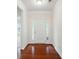 Bright foyer with hardwood floors, a white front door with sidelights, and fresh paint, creating a clean and inviting space at 6007 Edinburgh Ln # 214, Indian Land, SC 29707