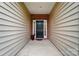 Inviting front porch with a classic black door, framed by neutral siding and brick accents, offering a warm welcome at 6007 Edinburgh Ln # 214, Indian Land, SC 29707
