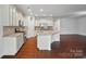 Bright, open kitchen features granite countertops, stainless steel appliances, and a large center island at 6007 Edinburgh Ln # 214, Indian Land, SC 29707