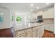 Spacious kitchen island features granite countertops, sink, and stainless steel appliances at 6007 Edinburgh Ln # 214, Indian Land, SC 29707