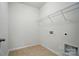 Bright laundry room with tile floors and built-in wire shelving for efficient storage at 6007 Edinburgh Ln # 214, Indian Land, SC 29707