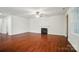 Expansive living room featuring gleaming hardwood floors, neutral walls, a cozy fireplace, and ample natural light at 6007 Edinburgh Ln # 214, Indian Land, SC 29707