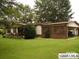 Ranch-style home with a lush lawn, mature trees, and a covered carport, offering a blend of comfort and outdoor charm at 634 Lippard Farm Rd, Statesville, NC 28625