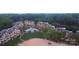 Aerial view of condo complex with pool, greenery, and lake access at 635 Portside Dr, Davidson, NC 28036