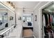 A luxurious bathroom featuring double sinks, marble countertops, and a view of the bedroom and walk-in closet at 635 Portside Dr, Davidson, NC 28036