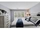 Cozy bedroom featuring a bright window, comfortable bed, and modern gray decor at 635 Portside Dr, Davidson, NC 28036