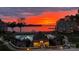 Stunning sunset view of the community pool, lake and clubhouse, showcasing the resort-style amenities at 635 Portside Dr, Davidson, NC 28036