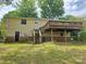 Home exterior featuring a wooden deck, stairs, and access to the backyard at 7021 Willow Bend Ln, Mint Hill, NC 28227