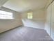 Unfinished carpeted basement with natural light and ample potential at 7021 Willow Bend Ln, Mint Hill, NC 28227