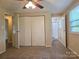 Bedroom featuring a ceiling fan, carpeted floors and an attached bathroom at 7021 Willow Bend Ln, Mint Hill, NC 28227