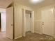 Bedroom with neutral walls, carpeted floors, and double door closet at 7021 Willow Bend Ln, Mint Hill, NC 28227