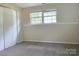 Bedroom with neutral walls, carpeted floors, and a large window at 7021 Willow Bend Ln, Mint Hill, NC 28227